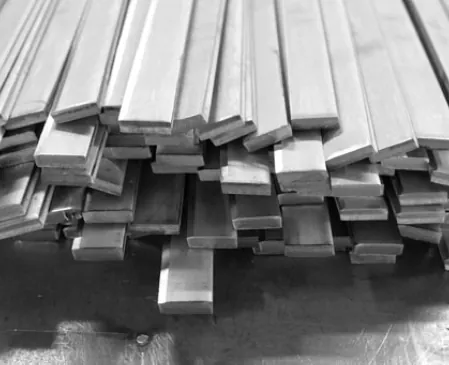 Workers discussing steel material requirements in an industrial facility